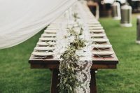 a lace and greenery table runner are a cool idea for a rustic wedding, can be rocked for an outdoor one