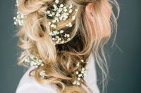 a messy braided ponytail with baby’s breath tucked in and some locks down is a lovely idea for a spring or summer boho bride