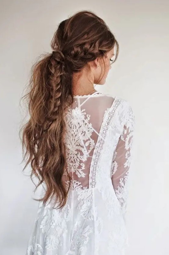 a messy long ponytail with a couple of braids incorporated and a bump on top is a lovely idea for a boho bride