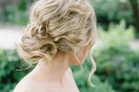 a messy wavy and twisted updo for an effortlessly chic bride, it will be easy to make yourself if needed