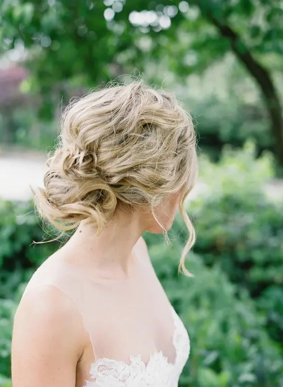 a messy wavy and twisted updo for an effortlessly chic bride, it will be easy to make yourself if needed