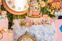 a pastel wedding cake table in pink and blue, with bright blooms and oversized clocks looks very whimsy