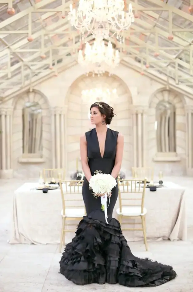a plunging neckline sleeveless mermaid wedding dress with a ruffled tail and a train is a gorgeous idea for a modern refined wedding