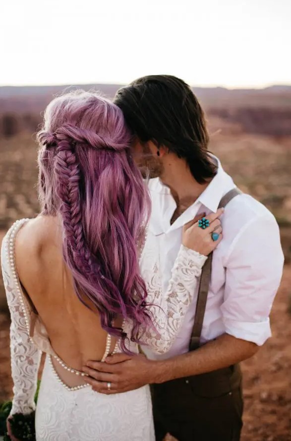 a purple half updo with a twisted fishtail braid and some waves down is a lovely idea for a destination bride