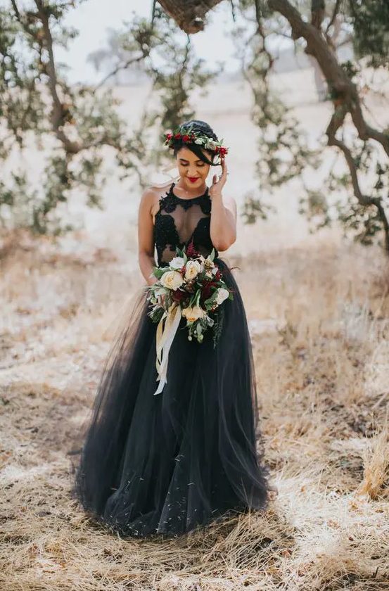 a sleeveless halter neckline wedding dress with an illusion bodice and a layered tulle skirt is a fantastic idea for a sexy witchy wedding look