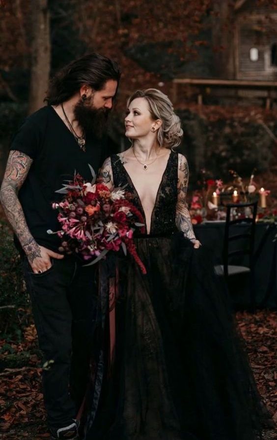 a stunning black lace A-line wedding dress with a plunging neckline and thick straps plus pockets is a gorgeous idea for Halloween
