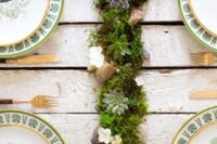 a stylish wedding centerpiece of moss, white blooms and pale succulents in the center is a cute rustic and all-natural idea
