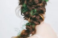 a twisted messy braid with greenery tucked in instead of flowers is a lovely idea for a spring boho bride