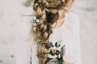 a very dimensional and textural braid made of two side ones with fresh flowers is a great destination hair solution