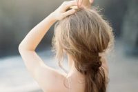 a very messy low ponytail with some beach waves is ideal for beach and tropical brides