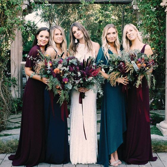 all mismatched bridesmaids' looks in plum and teal dresses to show off the personal style of each girl