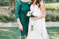 an emerald lace midi fitting dress with a bateau neckline and black shoes are a great combo for a fall wedding