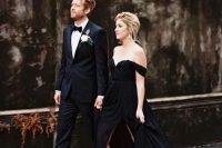 an off the shoulder black wedding gown with a side slit looks very chic and elegant and will do for a sophisticated wedding