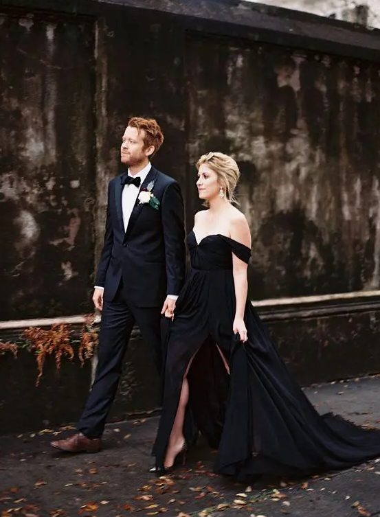 an off the shoulder black wedding gown with a side slit looks very chic and elegant and will do for a sophisticated wedding