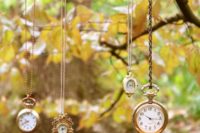 hanging wedding decor with lots of vintage pocket watches is amazing for a whimsy Alice in Wonderland wedding