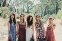 mismatched floral print bridesmaid maxi dresses in bold colors and floral crowns for a boho wedding in summer or fall