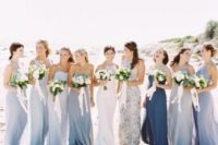 mismatched maxi bridesmaid dresses in blue shades and a floral print one for a coastal wedding