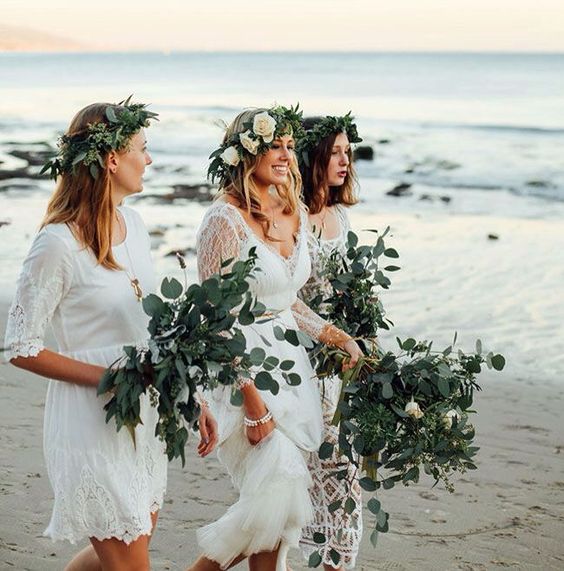 mismatched white lace dresses with a boho feel and greenery crowns for a boho beach wedding