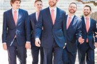 navy suits and coral pink ties for bright and fun groom and groomsmen attire with much color