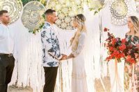 oversized lace embroidery hoops as a wedding backdrop, greenery and blooms, a colorful rug are a great idea for a boho wedding