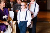 ring bearers rocking navy pants and suspenders, white shirts and coral pink ties for a cool look