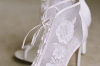 Victorian Era inspired white lace peep toe wedding booties with lacing up for a fashionable statement
