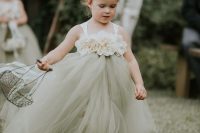 a beautiful flower girl dress of fabric blooms on the bodice and a green tulle skirt is a stylish idea with a girlish feel