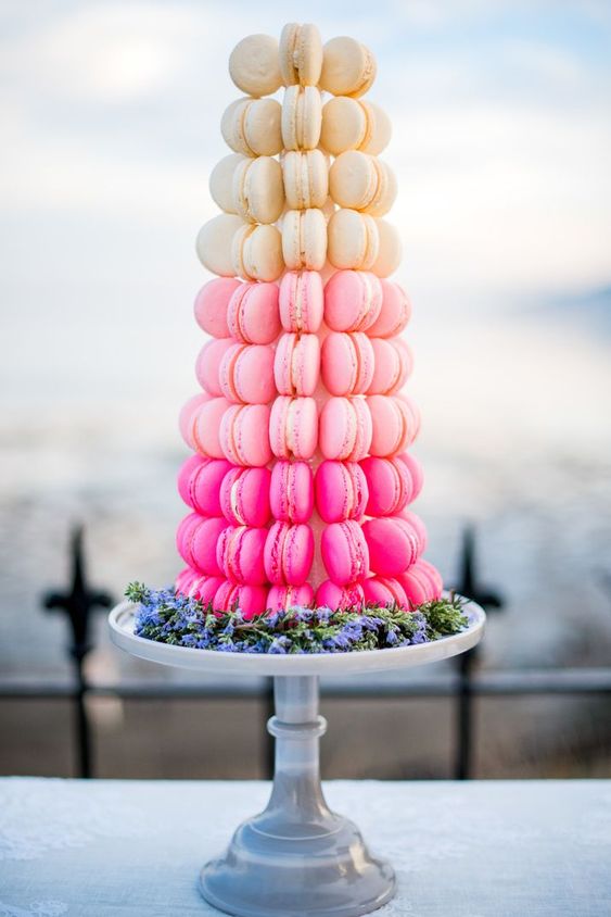 a beautiful ombre macaron tower from neutral to light and hot pink is a stylish alternative to a usual wedding cake