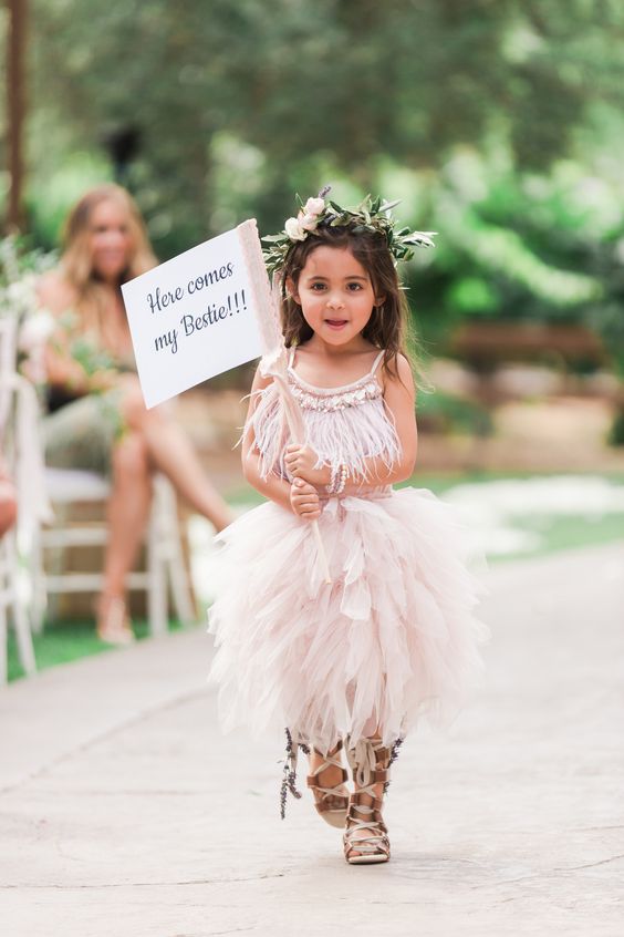 a blush midi flower girl dress with an embellished feather bodice and a layered skirt plus gladiator sandals for a bold look