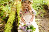 a boho flower girl in an a-line boho embroidered dress with short sleeves and a flower crown plus a chic bouquet