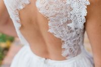 a chic A-line wedding dress with a lace bodice and a keyhole back on buttons plus a pleated layered skirt is cool