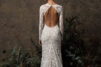 a chic boho lace mermaid wedding dress with a keyhole back, long sleeves, a high neckline and a short train is a lovely idea for a modern space