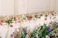 a chic neutral indoor venue spruced up with colorful blooms and jaw-dropping florals and greenery at the table