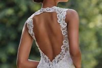 a dreamy fitting wedding dress with lace appliques, with a keyhole back and a high neckline and no sleeves for a modern and charming bride