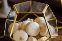 a faceted glass box with gold leaf macarons – this is a simple and cool way to serve them at your wedding