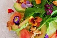 a fresh salad with avocado, nuts, arugula, pansies, nasturtium is very light and cool for a spring or summer wedding