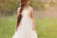 a glam flower girl with a gold sequin bodice and a layered skirt is a bright and shiny idea to try