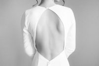 a gorgeous minimalist fitting wedding dress with a keyhole back, long sleeves, buttons and a high neckline is a lovely idea to rock