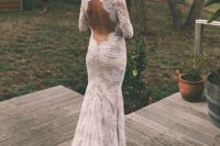 a lace mermaid wedding dress with long sleeves, a keyhole back, a short train and buttons on the back is a cool idea for a rustic bride