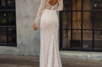 a mermaid lace wedding dress with a high neckline, long sleeves, a keyhole back and a short train with a touch of bling is amazing