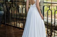 a modern wedding ballgown with a boho lace bodice, with a keyhole back, cap sleeves with tassels and a plain skirt with a small train