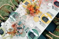 a neutral wedding table setting accented with bold floral centerpieces and matching candles and chargers looks fresh, edgy and modern