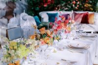 a neutral wedding tablescape with bold floral centerpieces and citrus is a fantastic idea for a colorful wedding