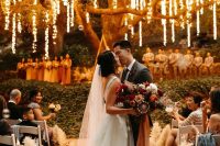 a romantic wedding ceremony space with lights hanging down from the tree make the space magical and gorgeous