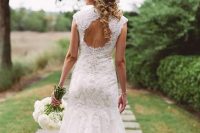 a vintage lace mermaid wedding dress with a keyhole back, cap sleeves, a high neckline and a short train for a refined wedding