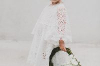 a white boho lace midi dress with bell sleeves, a high neckline and a moss and white bloom basket instead of a bouquet