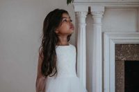 a white sleeveless knee flower girl dress with a lace bodice and a layered ruffle skirt is very stylish