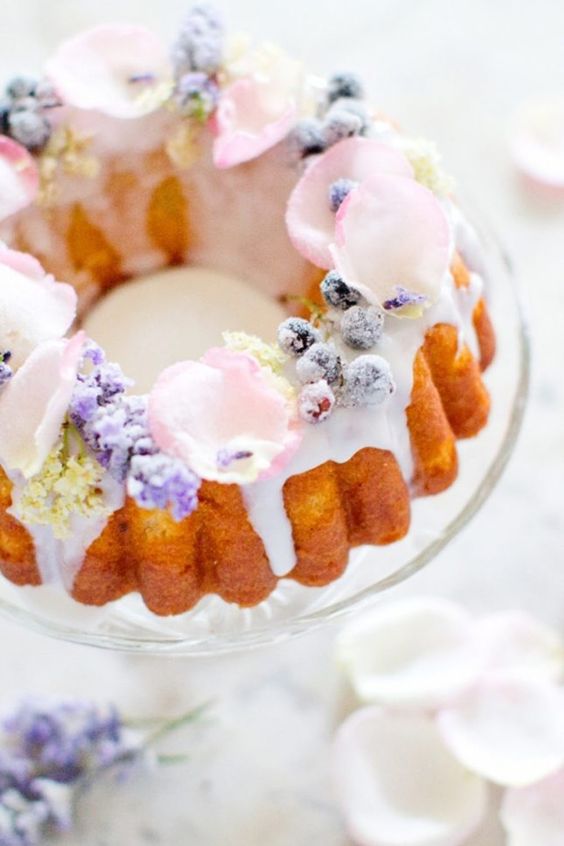 an adorable bundt wedding cake with creamy dip, sugared berries and candied edible flowers for a summer wedding