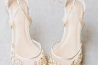 creamy sheer wedding shoes with white and gold embellishments attached in patterns are very sophisticated and intricate