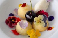 fruit sorbet and ice cream served with a cherry and sugared edible blooms is a refined wedding dessert